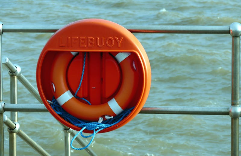 Orange lifebuoy marine safety equipment on ship